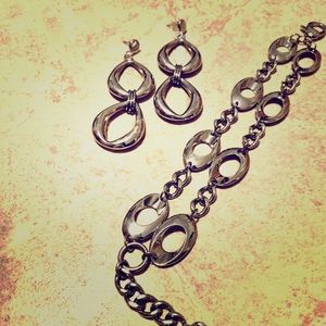 Silver-like earrings and bracelet.